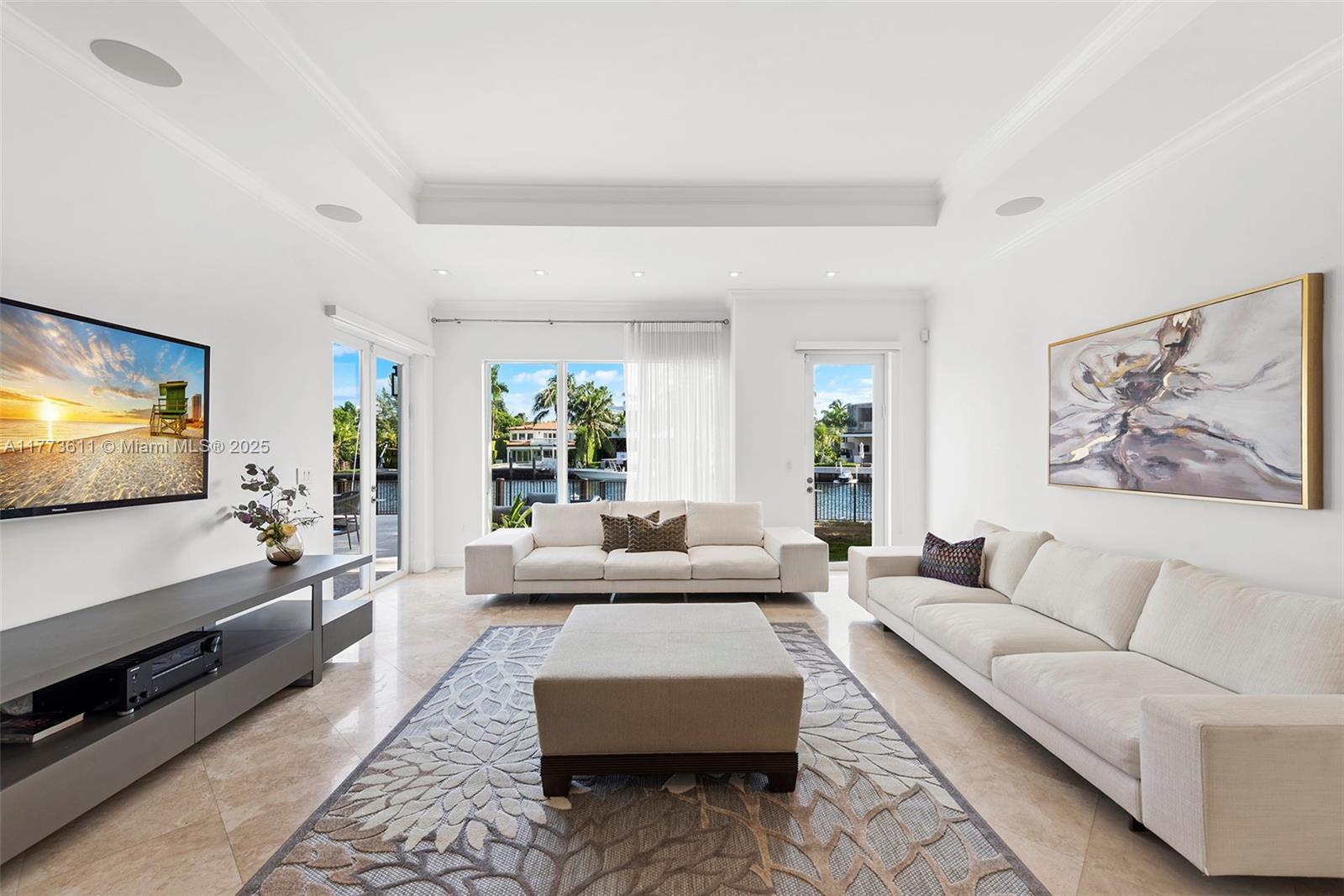 455 Centre Island Golden Beach, FL 33160 - Photo 21 of 67 a living room with furniture and a flat screen tv