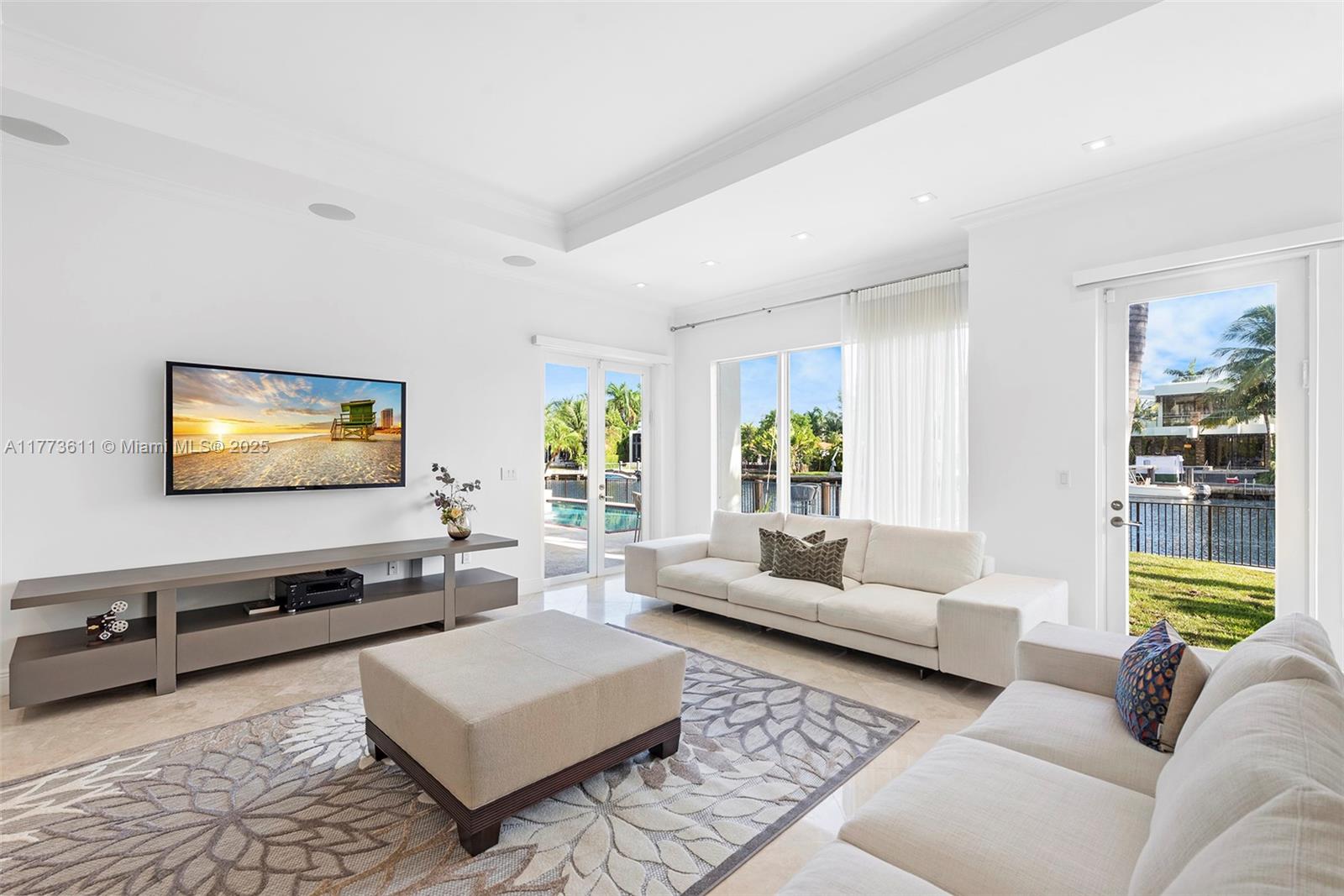 455 Centre Island Golden Beach, FL 33160 - Photo 22 of 67 a living room with furniture and a flat screen tv