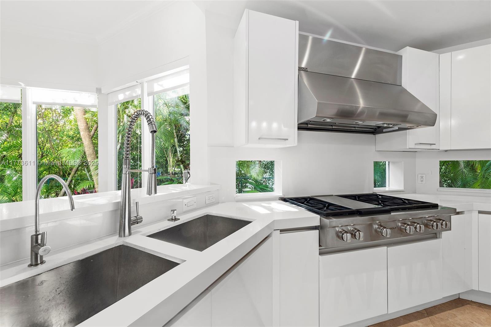 455 Centre Island Golden Beach, FL 33160 - Photo 27 of 67 a kitchen with granite countertop a stove and a sink