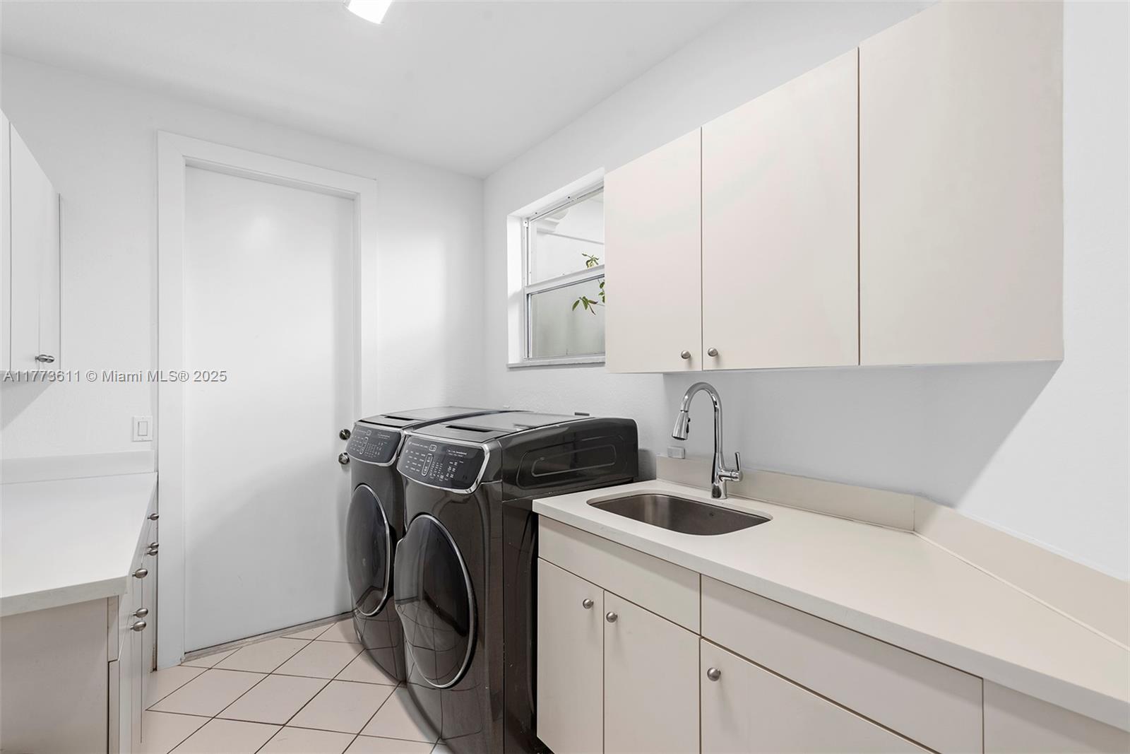 455 Centre Island Golden Beach, FL 33160 - Photo 30 of 67 a utility room with sink dryer and washer