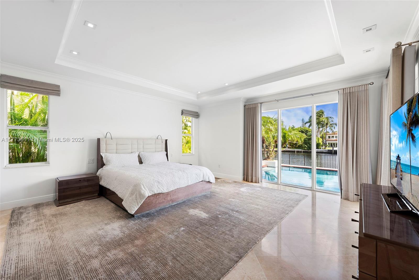 455 Centre Island Golden Beach, FL 33160 - Photo 33 of 67 a bedroom with a bed and a large window