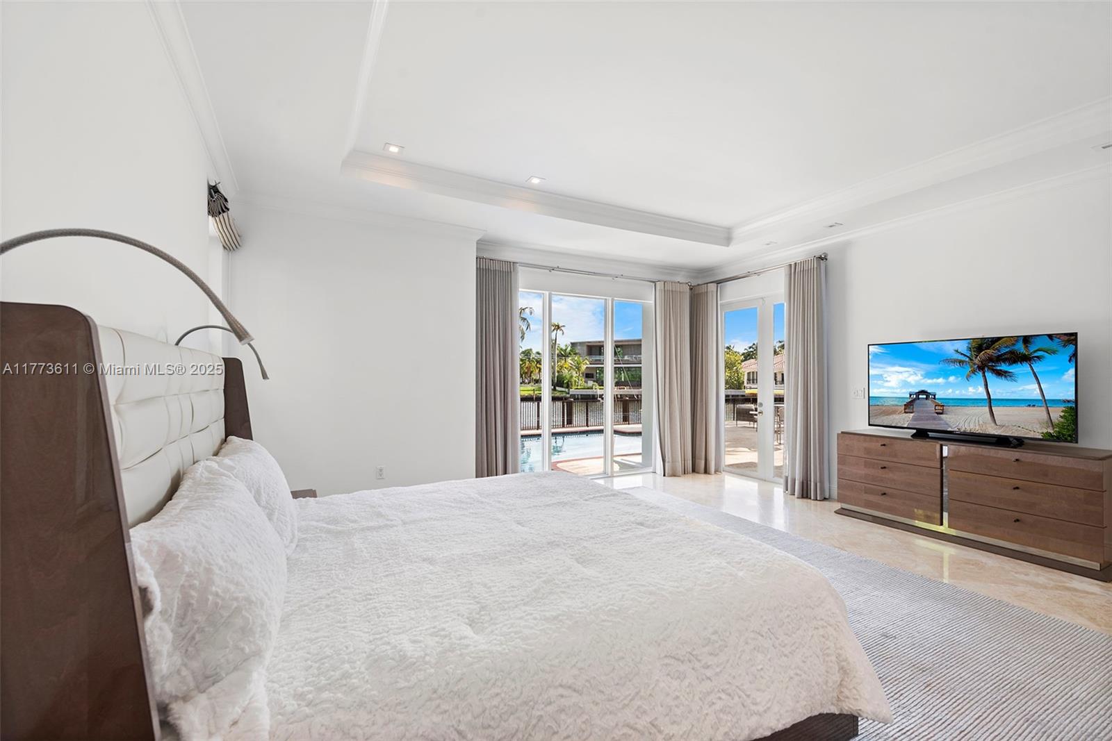 455 Centre Island Golden Beach, FL 33160 - Photo 34 of 67 a bedroom with a bed and a flat screen tv