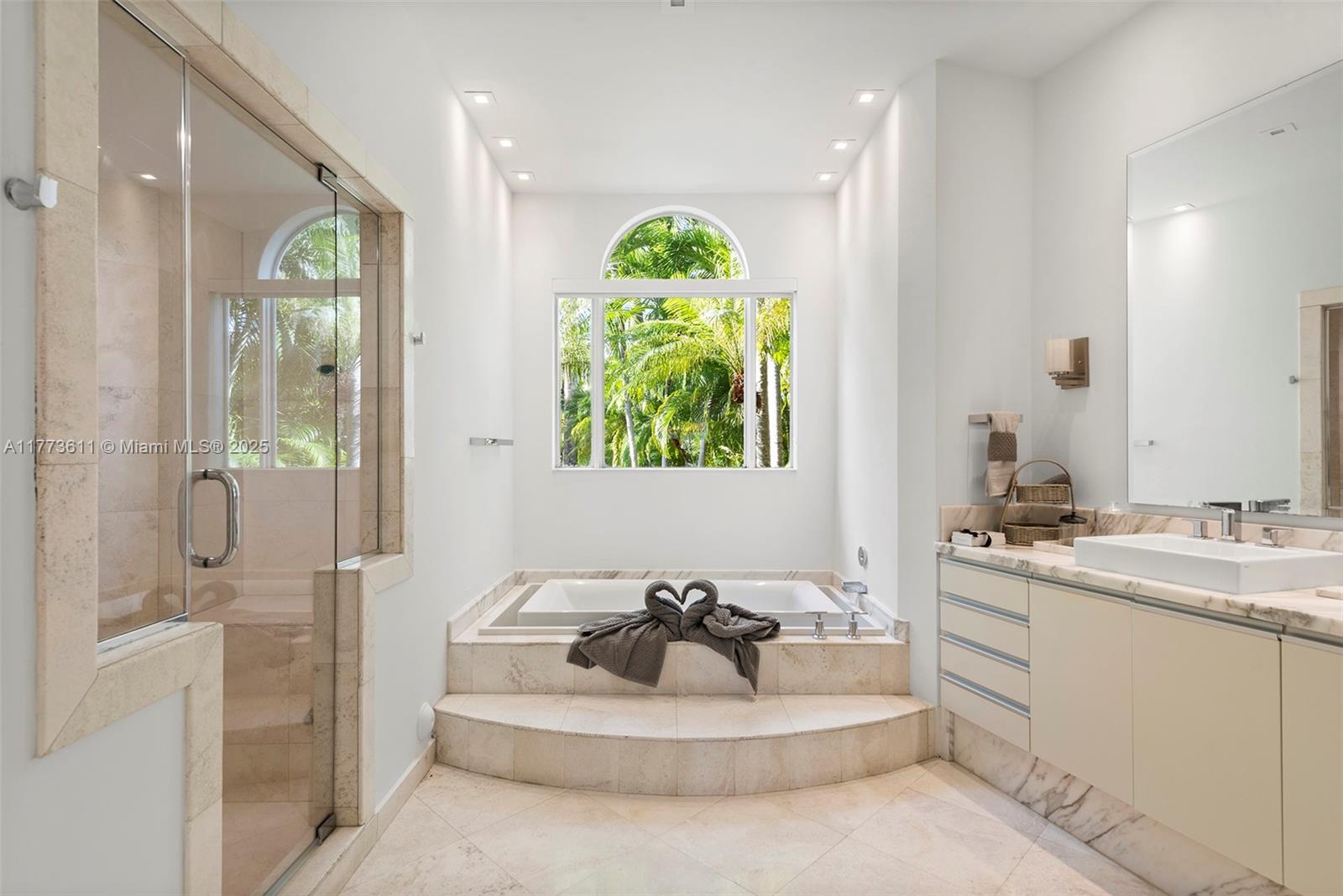 455 Centre Island Golden Beach, FL 33160 - Photo 37 of 67 a bathroom with a sink mirror and shower