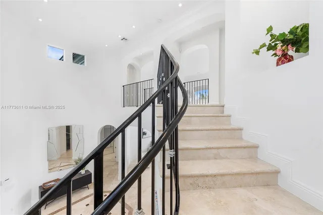 a large bed sitting in a spacious bedroom next to a window