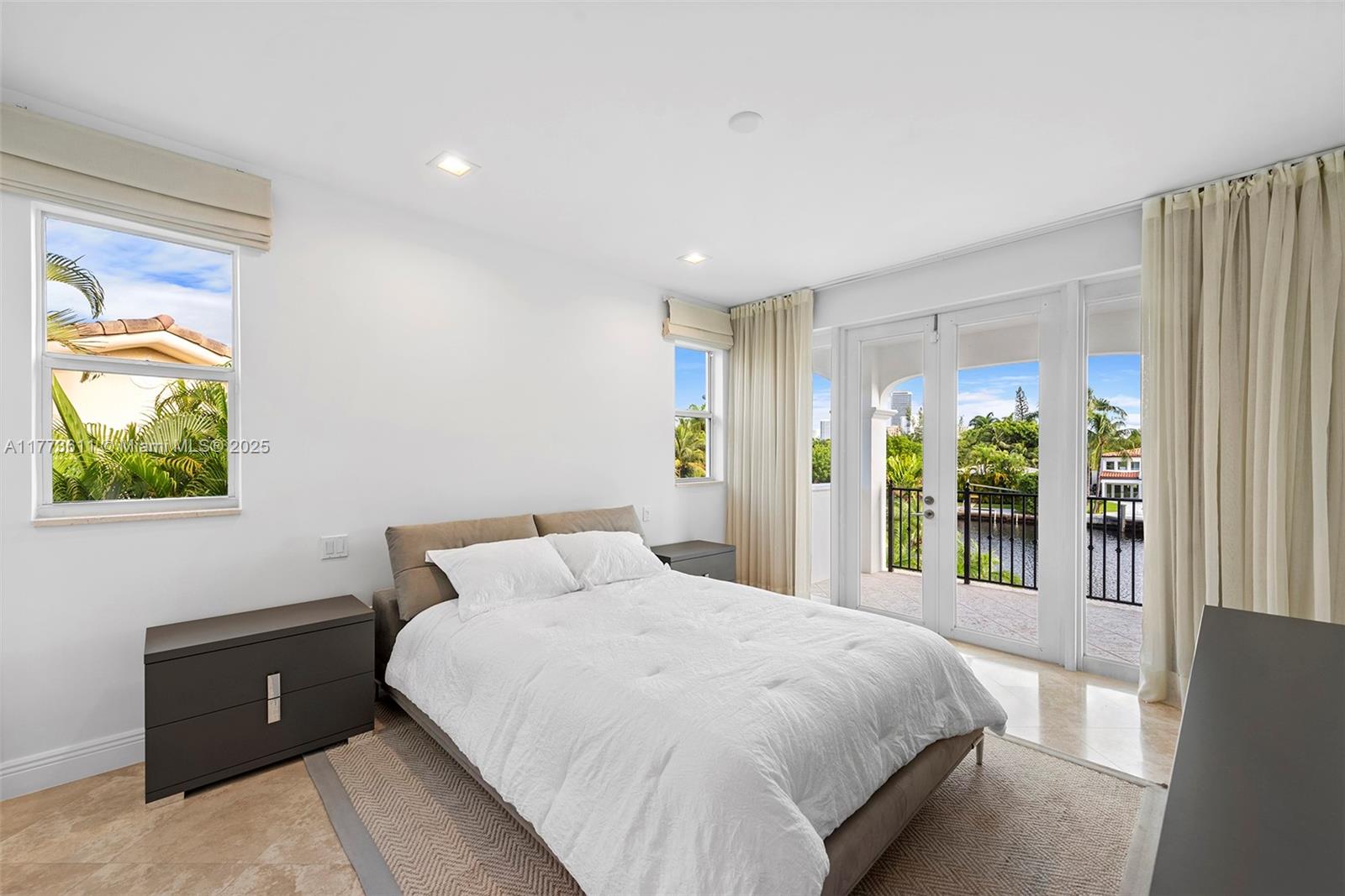 455 Centre Island Golden Beach, FL 33160 - Photo 42 of 67 a bedroom with a bed and a window