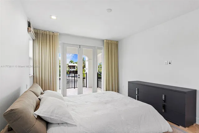 a view of a building with large windows and a table and chairs