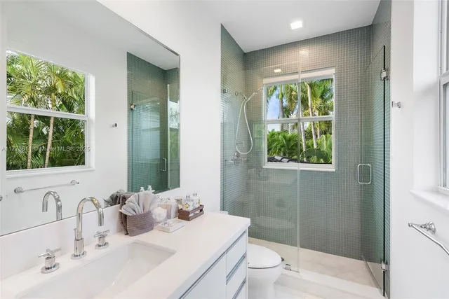 a view of a patio with couches and a table and chairs with plants and trees