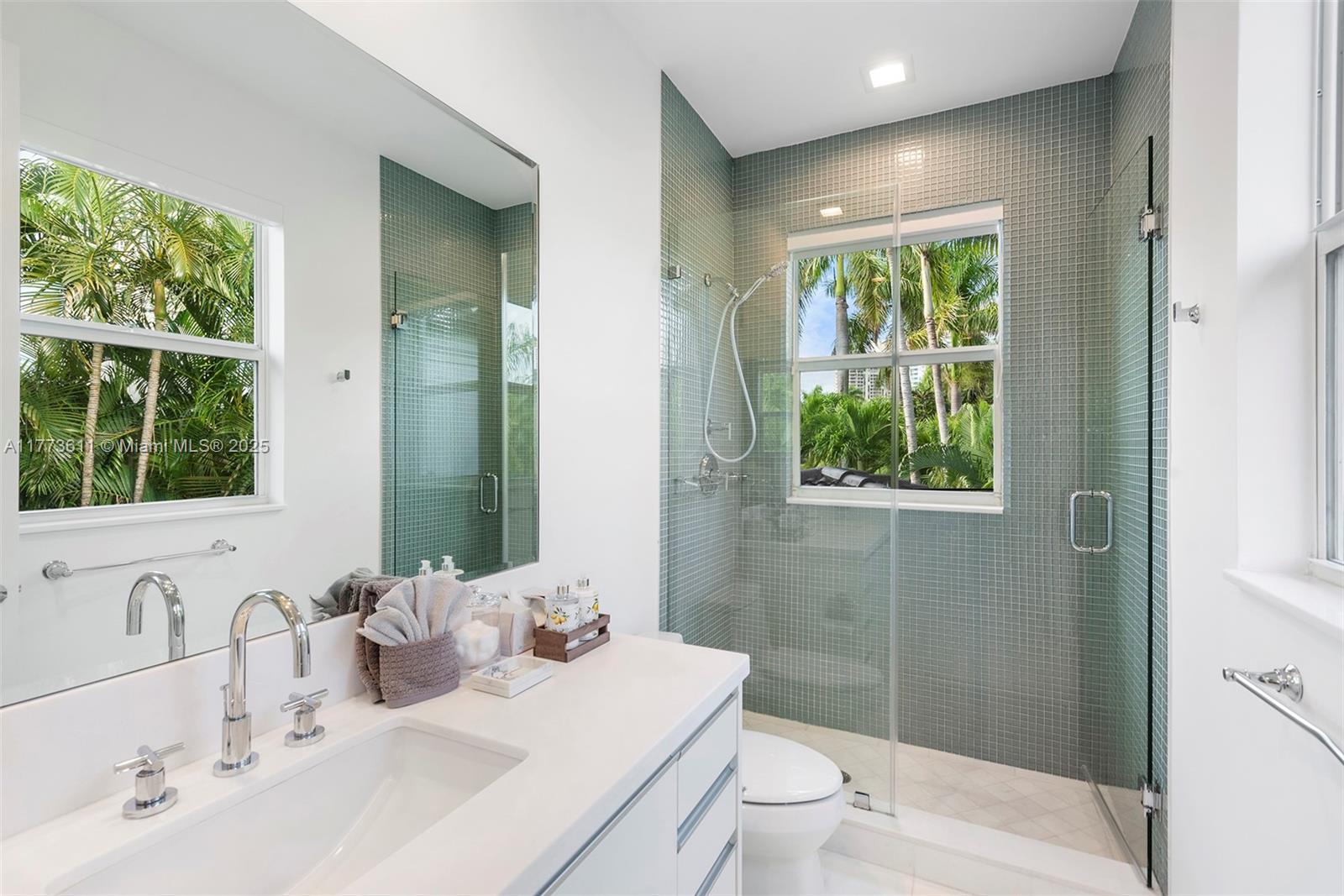 455 Centre Island Golden Beach, FL 33160 - Photo 44 of 67 a bathroom with a double vanity sink toilet and a mirror