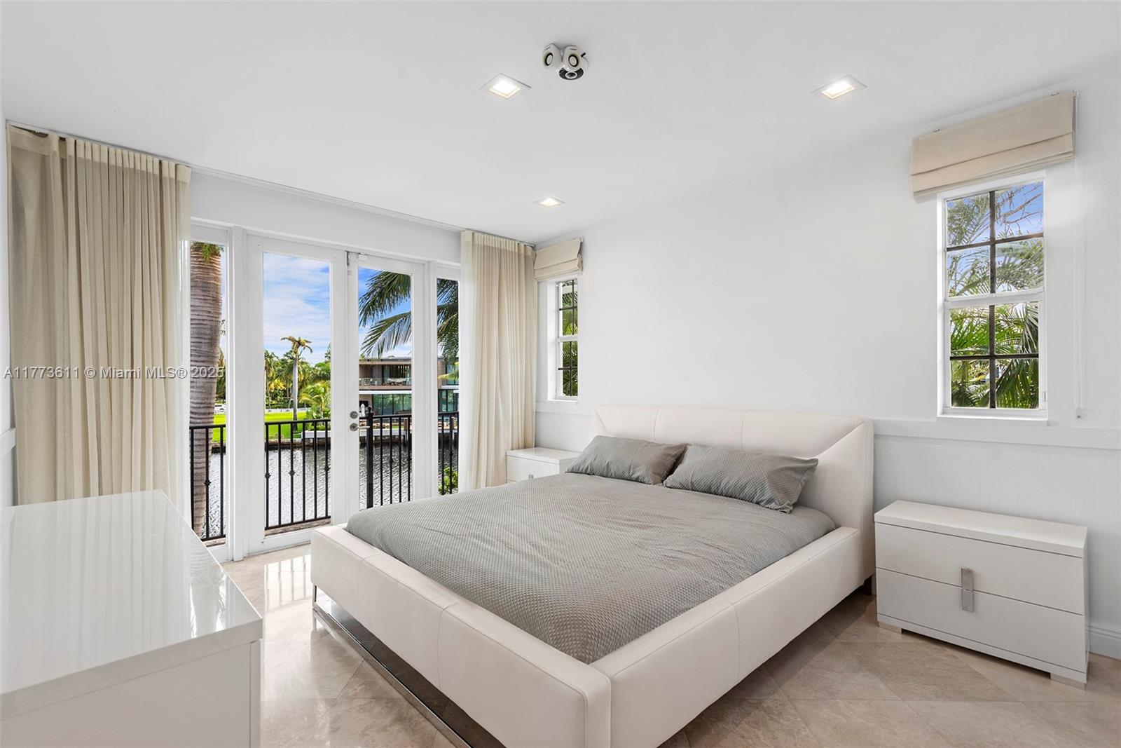 455 Centre Island Golden Beach, FL 33160 - Photo 47 of 67 a bedroom with a large bed and a window