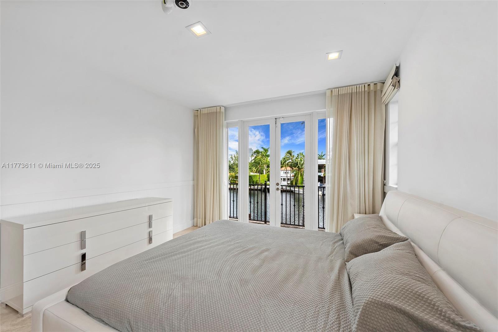 455 Centre Island Golden Beach, FL 33160 - Photo 48 of 67 a bedroom with a bed and a window