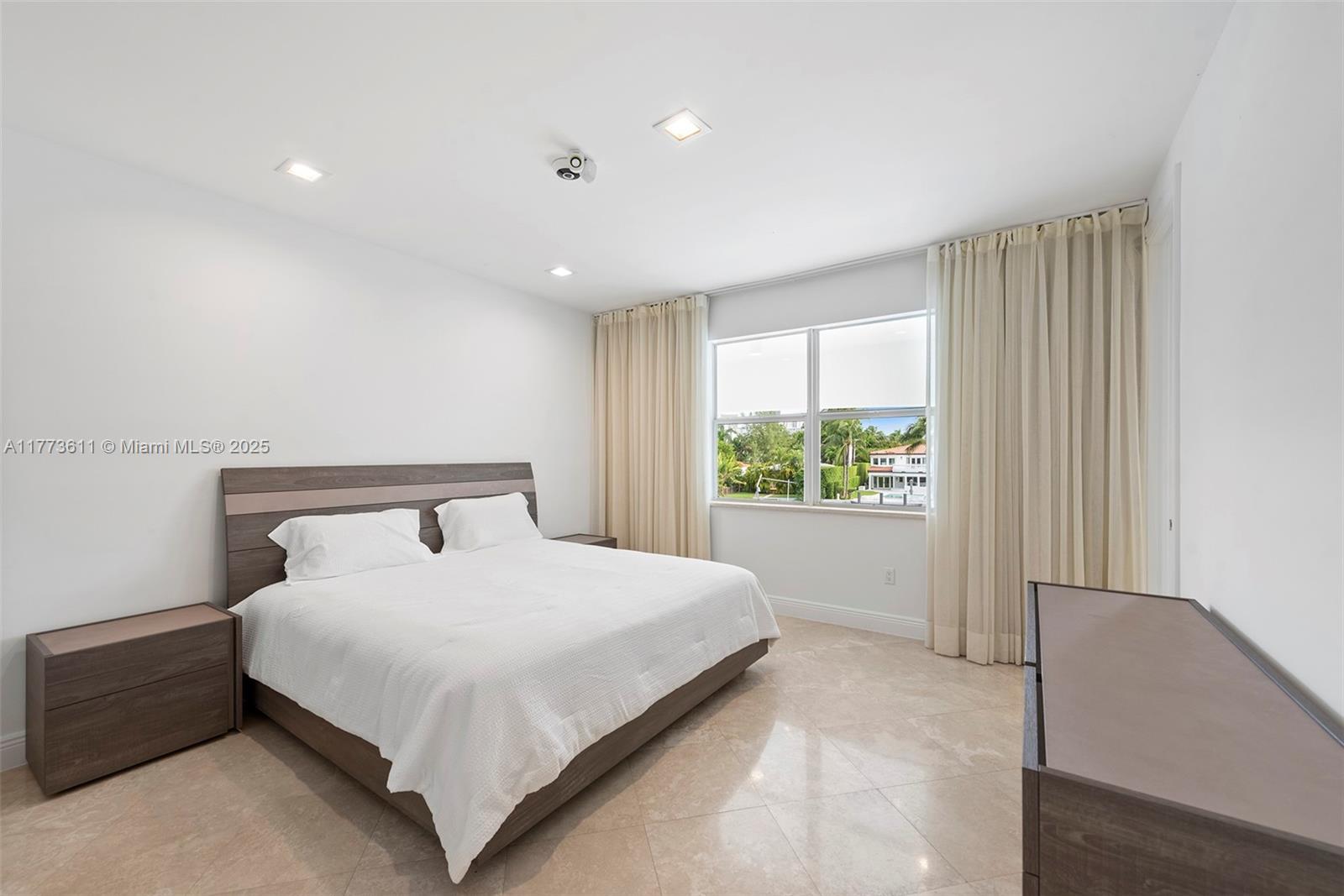 455 Centre Island Golden Beach, FL 33160 - Photo 53 of 67 a large bed sitting in a spacious bedroom next to a window