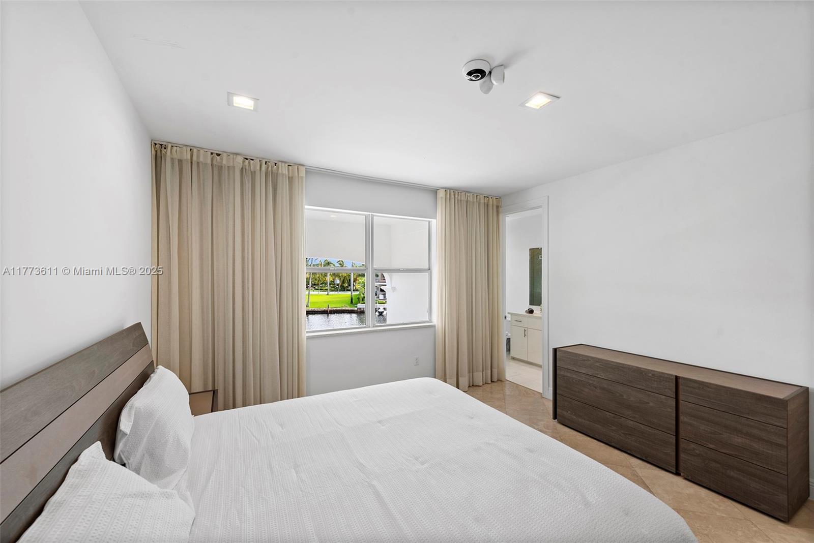 455 Centre Island Golden Beach, FL 33160 - Photo 54 of 67 a bedroom with a bed and a dresser