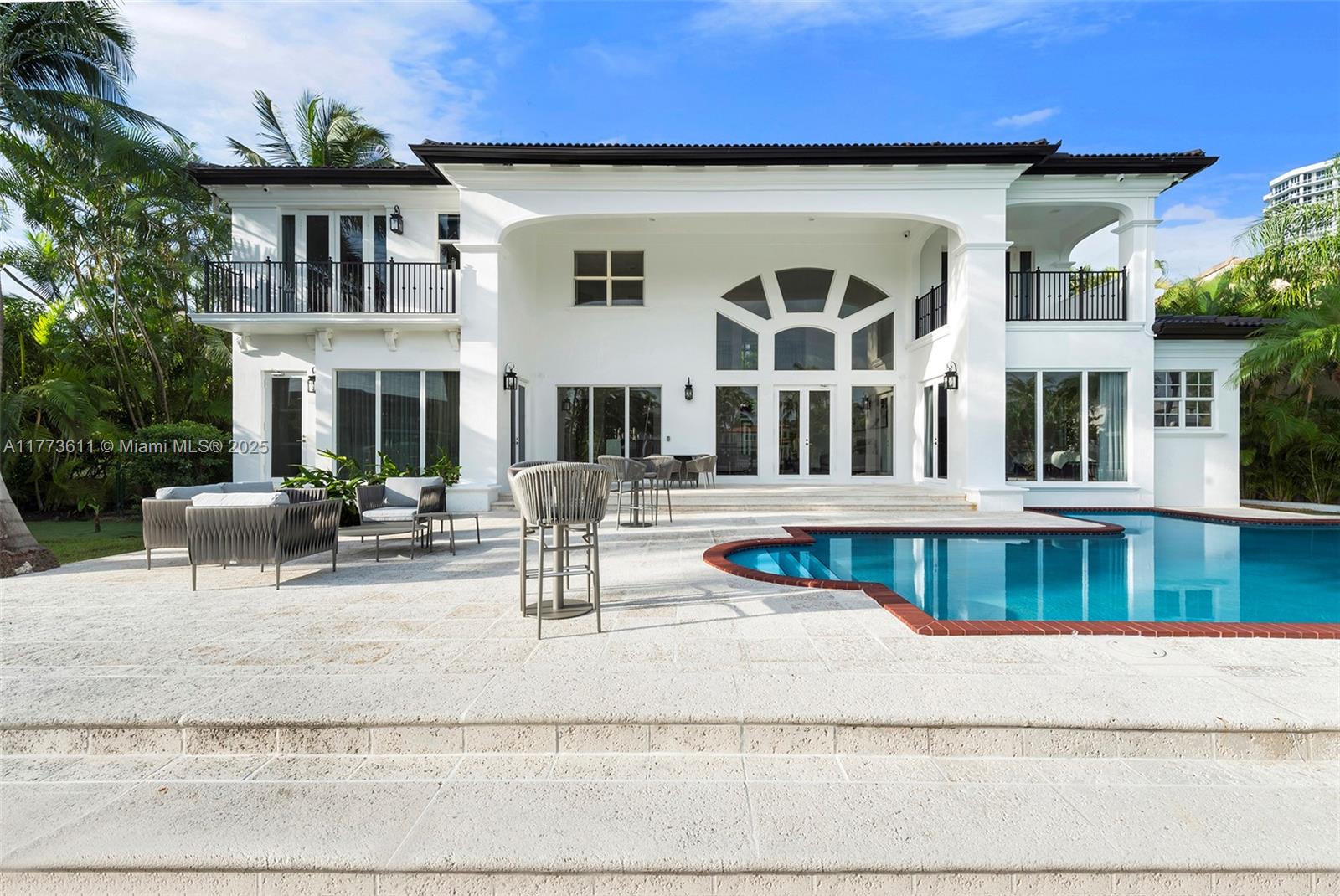 455 Centre Island Golden Beach, FL 33160 - Photo 56 of 67 a view of a building with large windows and a table and chairs