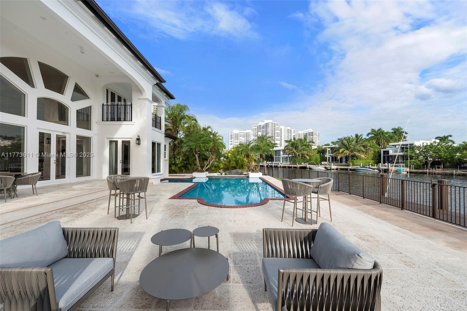 455 Centre Island Golden Beach, FL 33160 - Photo 59 of 67 a view of a patio with couches chairs and potted plants