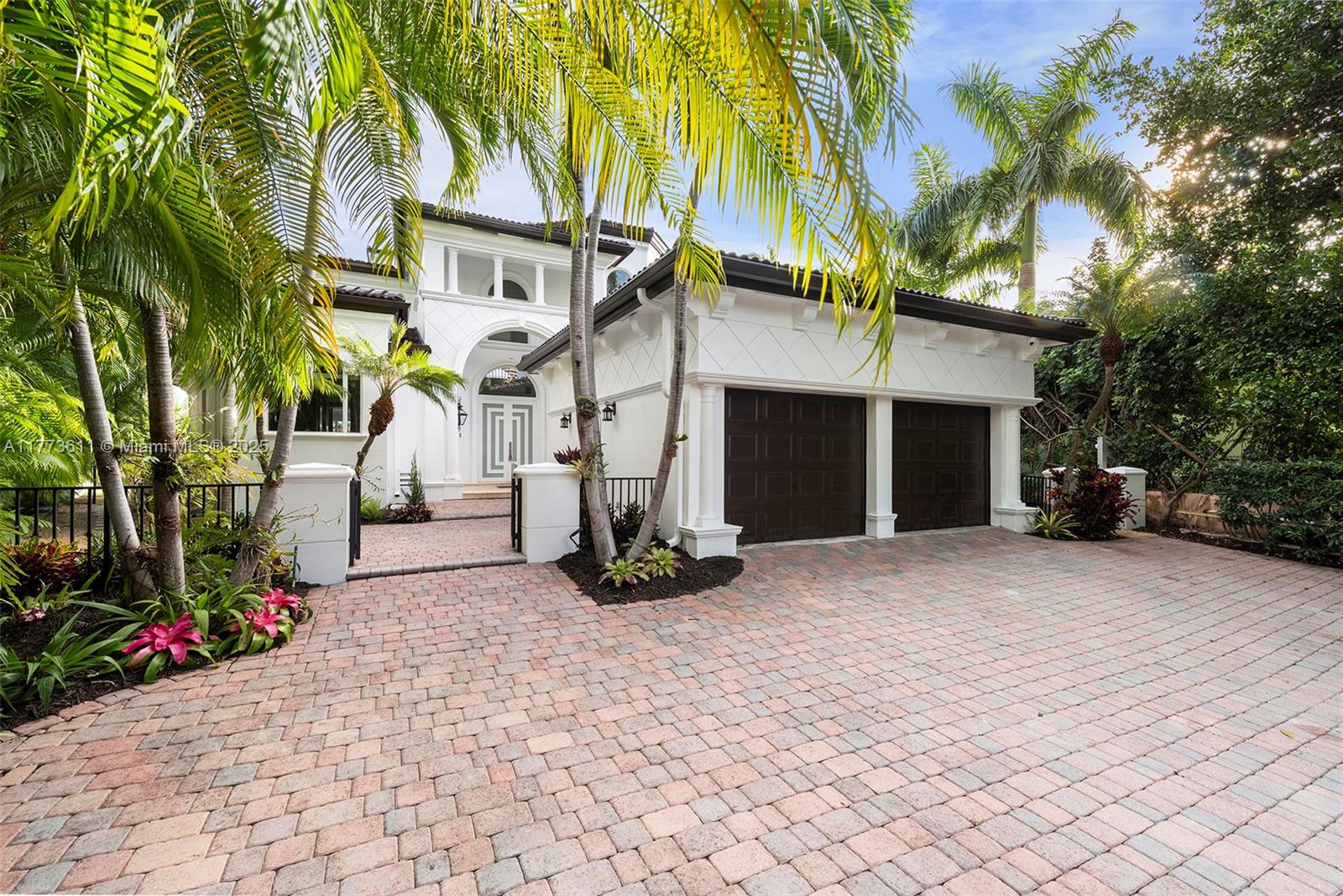 455 Centre Island Golden Beach, FL 33160 - Photo 8 of 67 a front view of a house with a yard and a garage