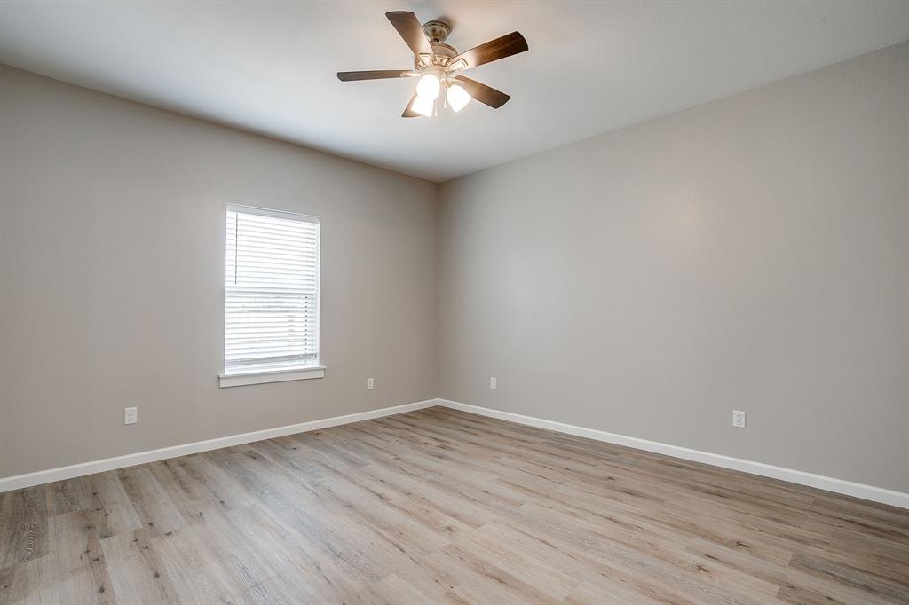 133 Winners Circle, Unit 202 Weatherford, TX 76087 - Photo 10 of 20 Unfurnished room with light wood-style floors and a ceiling fan