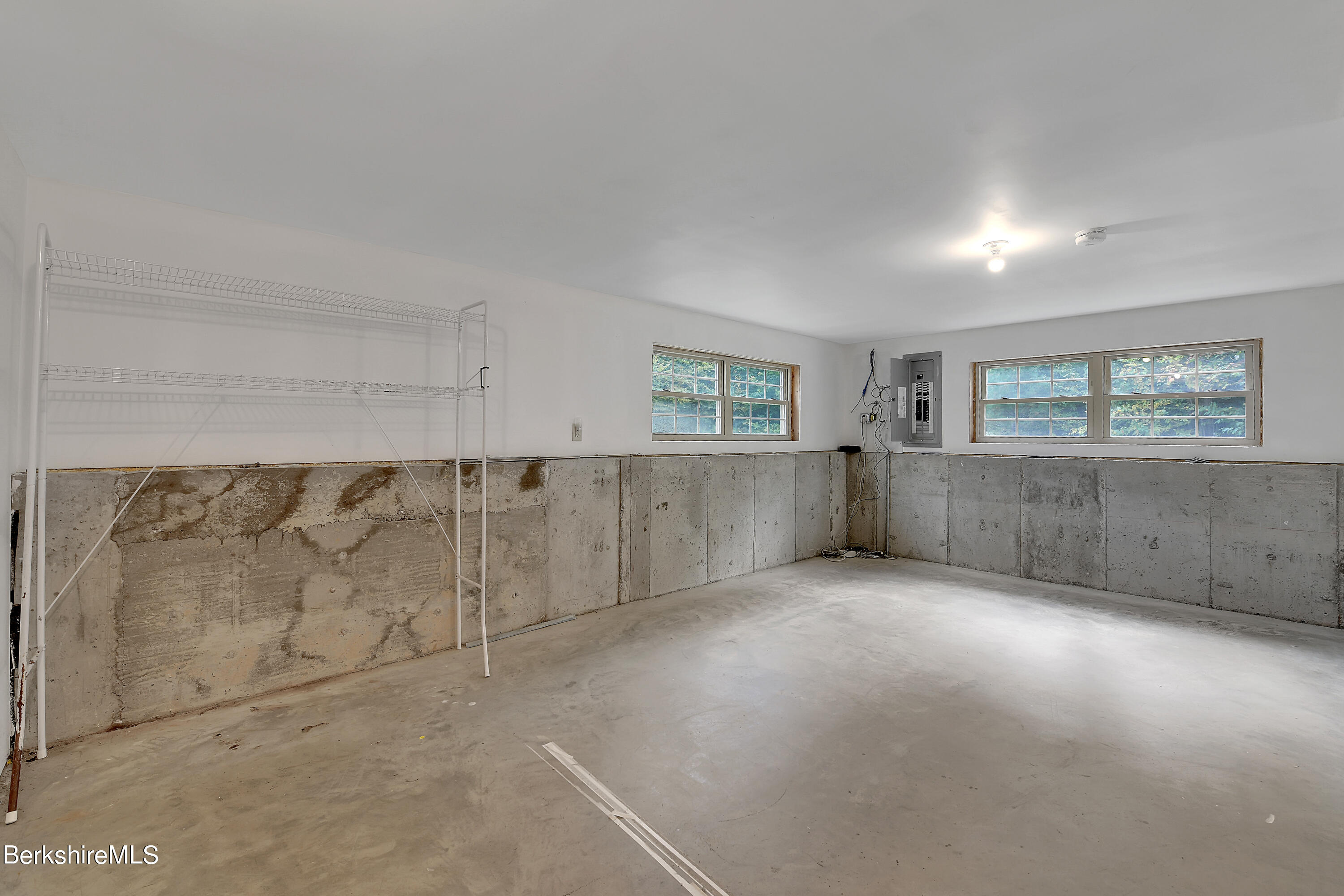 235 Fred Snow Road Becket, MA 01223 - Photo 22 of 30 an empty room with windows and pillars in it