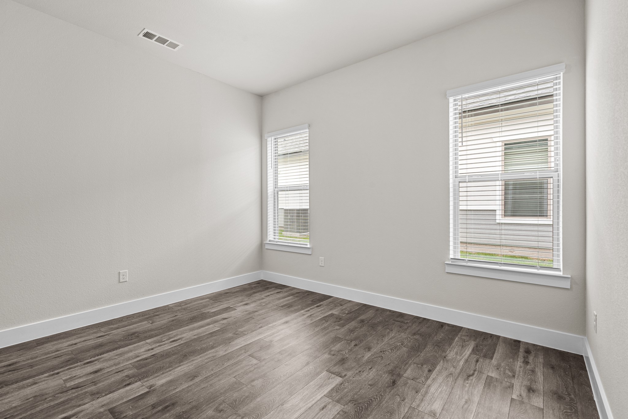 865 Limmer Loop, Unit 811 Hutto, TX 78634 - Photo 15 of 37 a view of empty room with wooden floor and fan