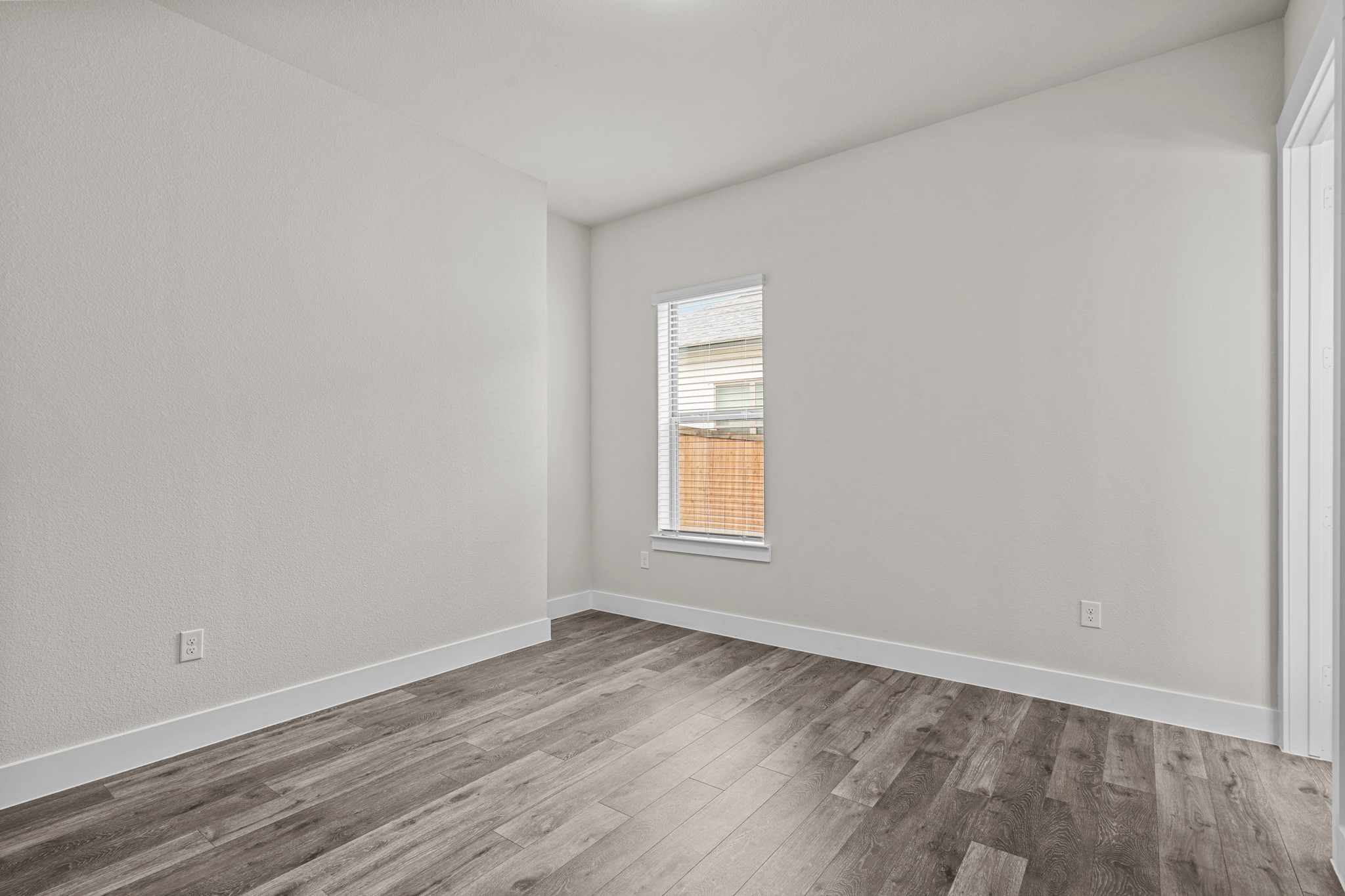 865 Limmer Loop, Unit 811 Hutto, TX 78634 - Photo 21 of 37 a view of empty room with wooden floor and fan