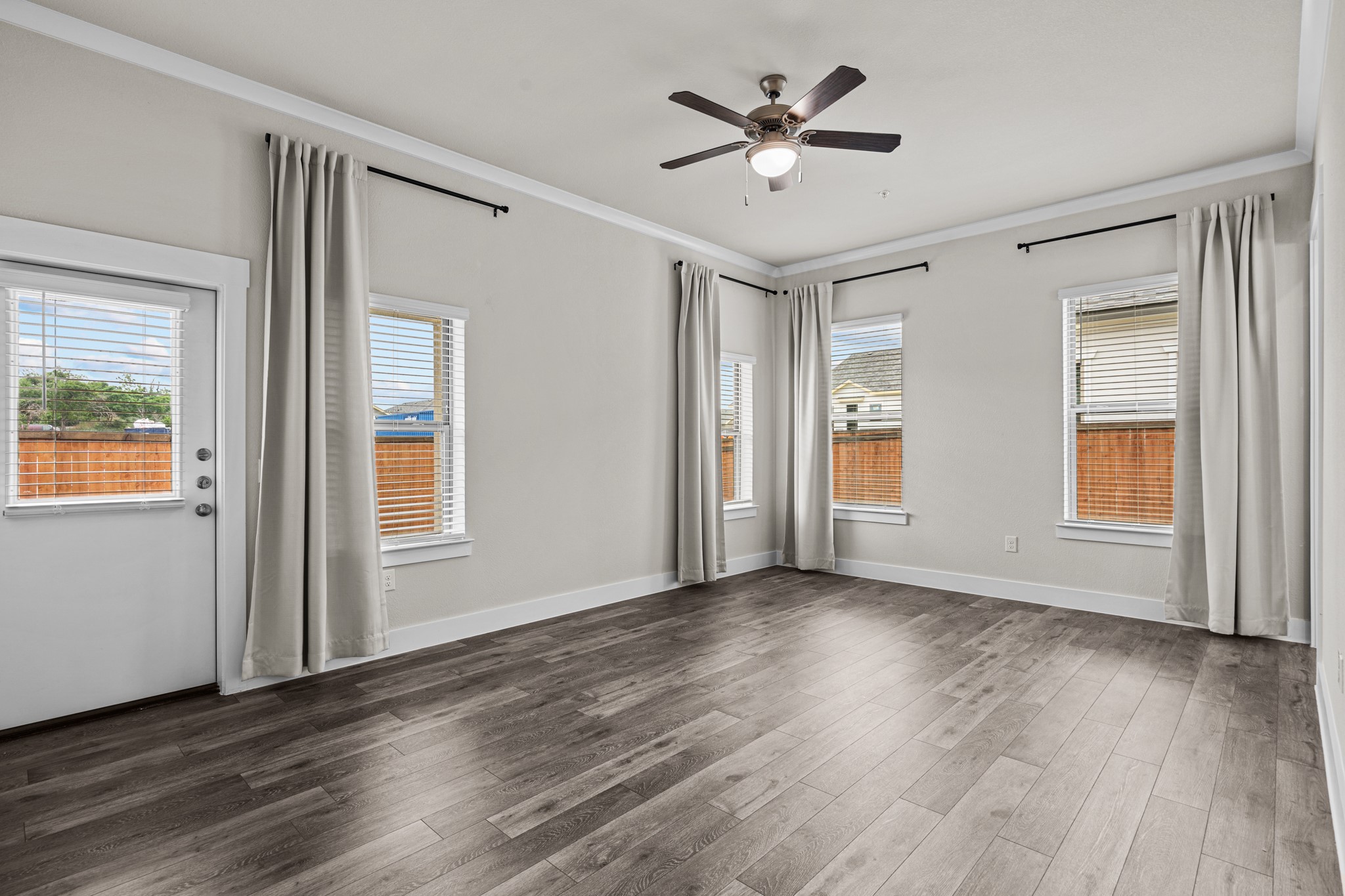 865 Limmer Loop, Unit 811 Hutto, TX 78634 - Photo 27 of 37 wooden floor in an empty room with a window