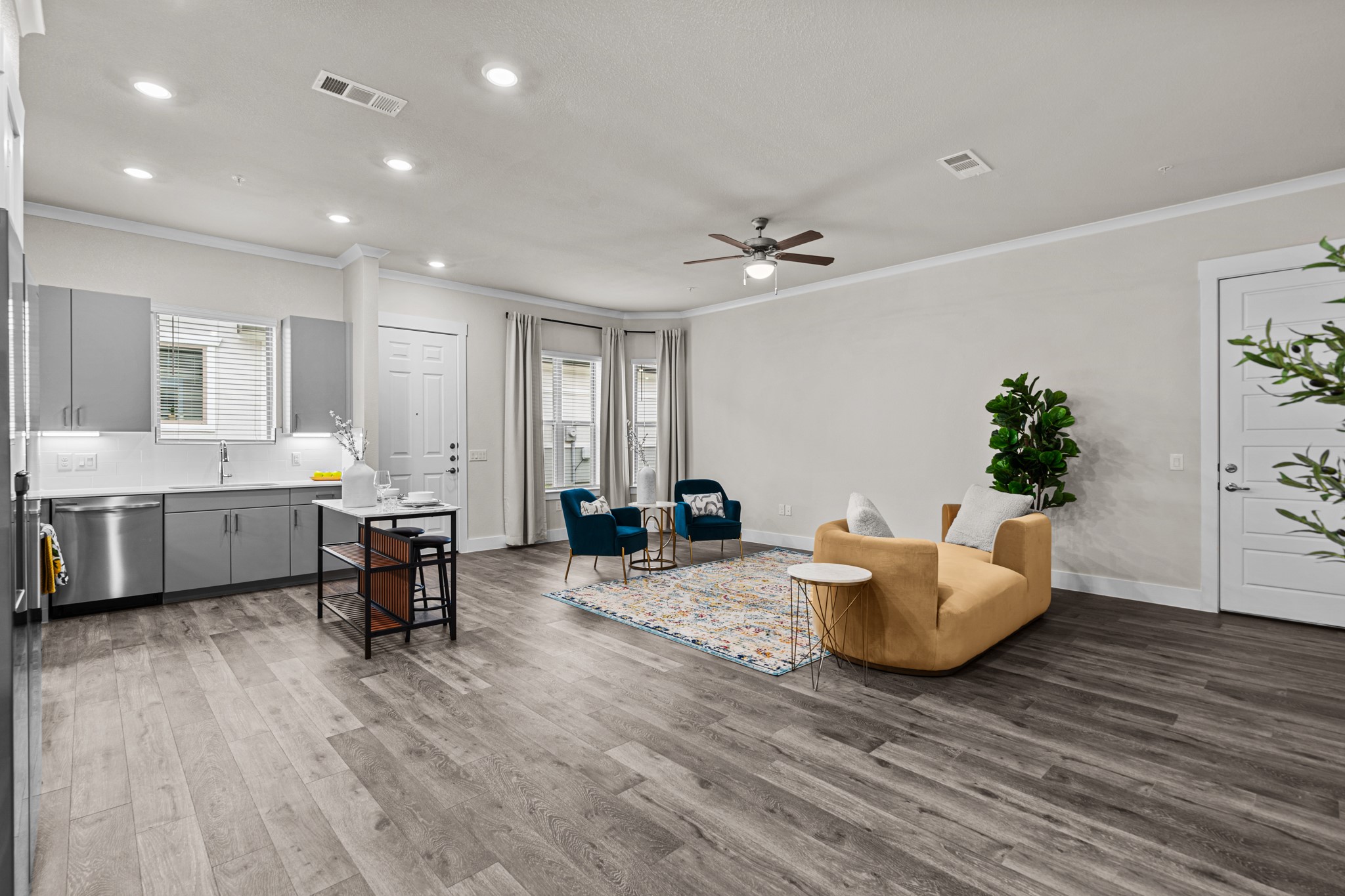 865 Limmer Loop, Unit 811 Hutto, TX 78634 - Photo 4 of 37 a living room with furniture and a wooden floor