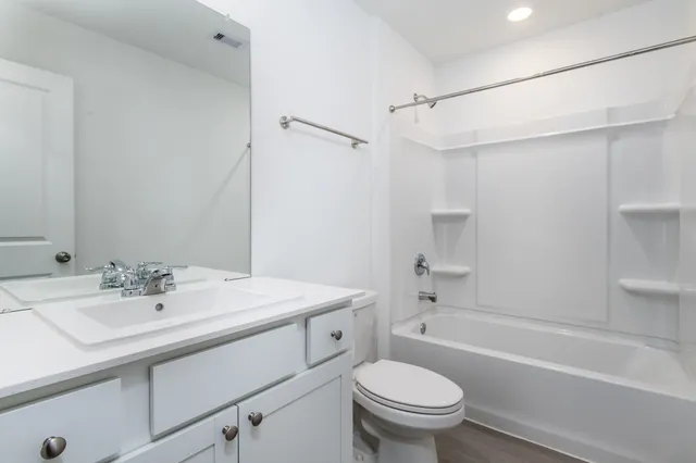 a bathroom with a sink a toilet and a bathtub