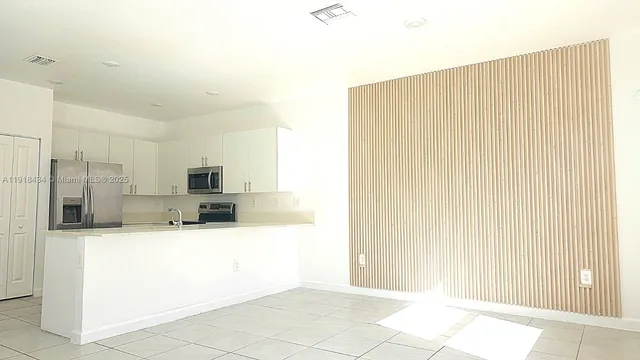 a large bathroom with a tub and sink