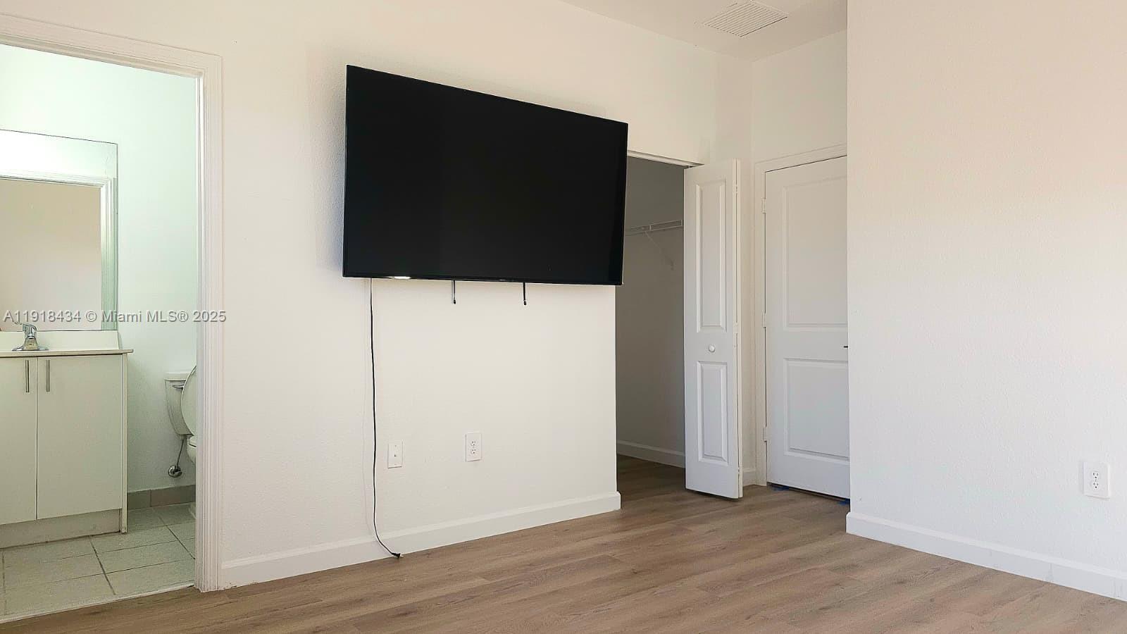 11774 Southwest 246th Street, Unit 11774 Homestead, FL 33032 - Photo 8 of 18 wooden floor in an empty room