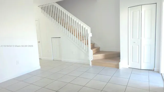 a view of an entryway with wooden floor