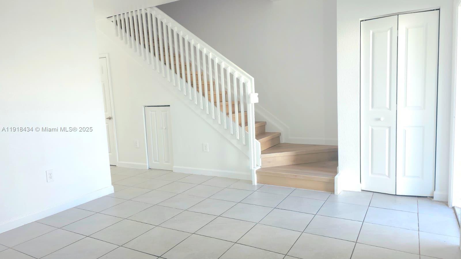 11774 Southwest 246th Street, Unit 11774 Homestead, FL 33032 - Photo 9 of 18 a view of an entryway with wooden floor