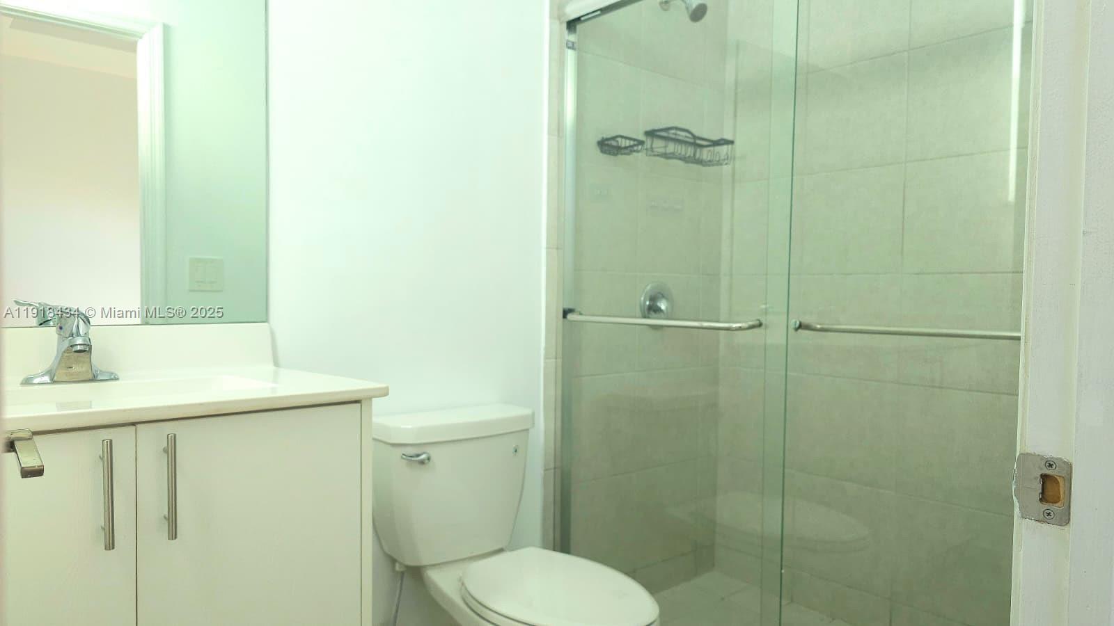 11774 Southwest 246th Street, Unit 11774 Homestead, FL 33032 - Photo 10 of 18 a bathroom with a sink a toilet and shower