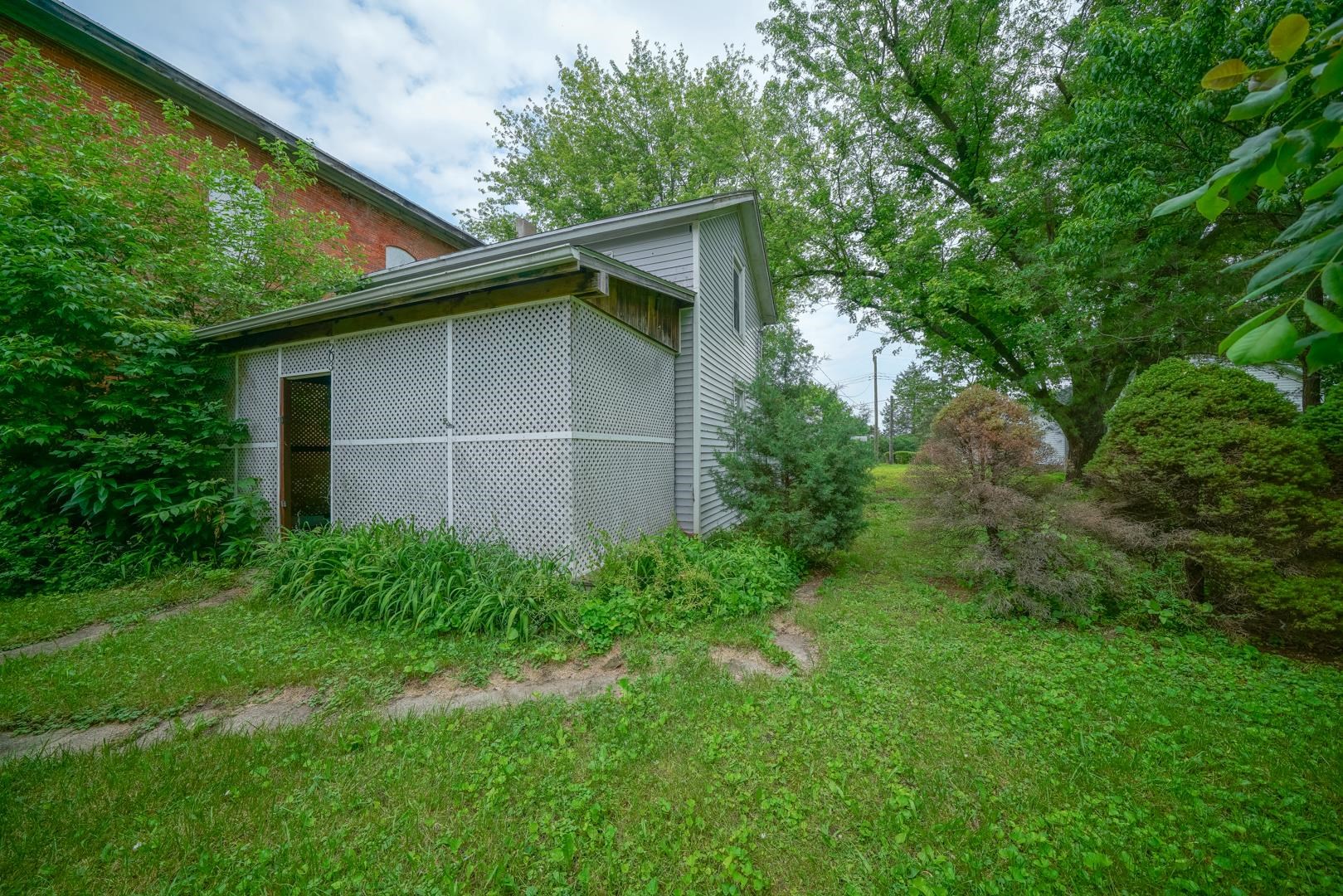 203 Adams Street Ridott, IL 61067 - Photo 3 of 24 a backyard of a house with lots of green space
