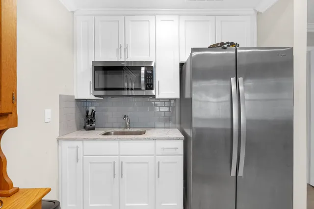 a kitchen with appliances cabinets and a counter top space