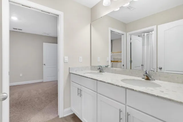a bathroom with a double vanity sink and a mirror