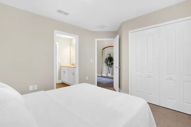 a bedroom with a bed and a table