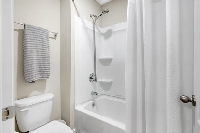 a bathroom with a toilet and a bathtub