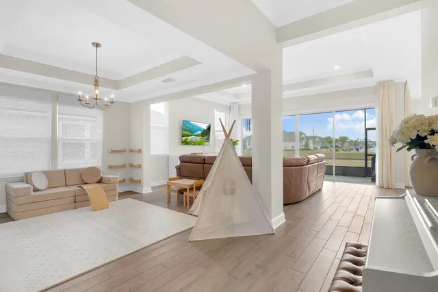 a living room with furniture and a view of kitchen