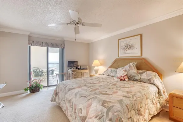 a bed sitting in a spacious bedroom next to a window