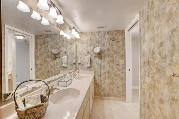 a bathroom with a granite countertop sink a toilet and shower