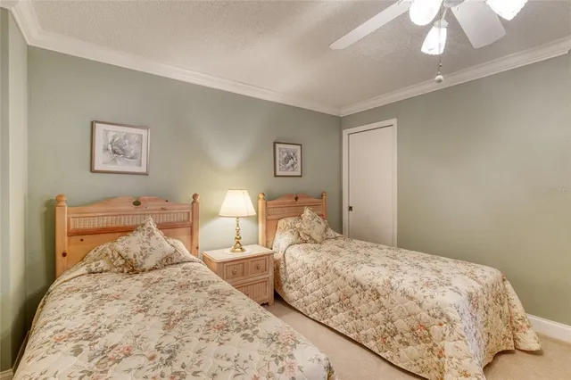 a bedroom with two beds and a chandelier