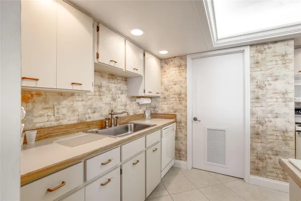 a kitchen with sink cabinets and window