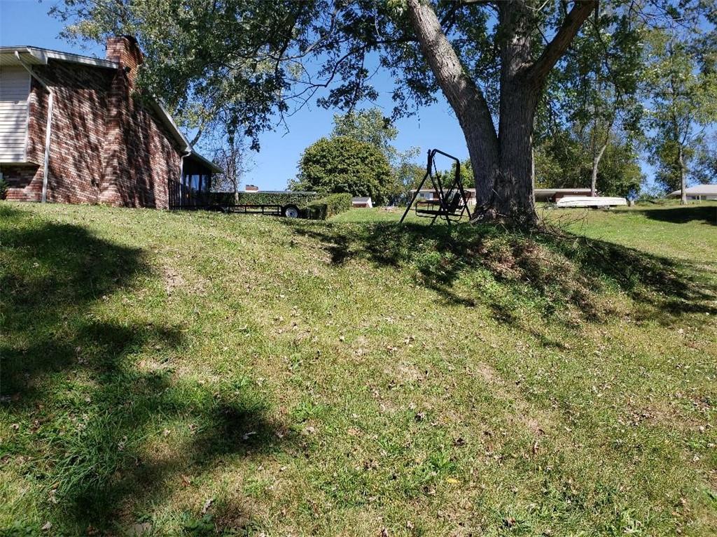 812 6th Street Rochester, PA 15074 - Photo 3 of 8 a view of a yard with plants and a large tree