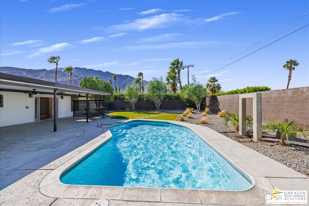 a view of a swimming pool with a chair and tables