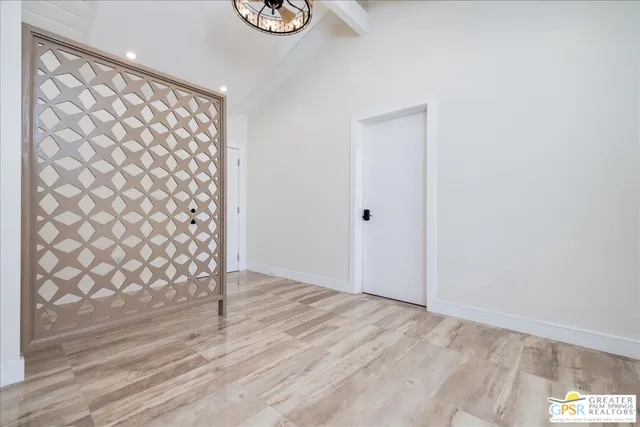 a view of a room with wooden floor and a window