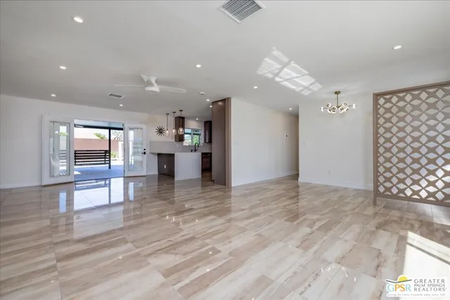 a view of a living room and kitchen with furniture wooden floor and window
