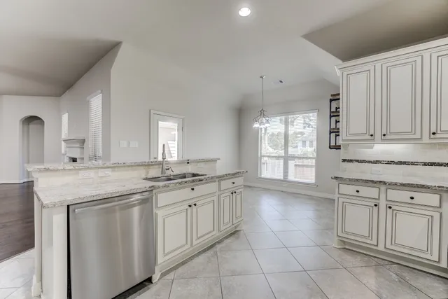 a kitchen with a sink and cabinets