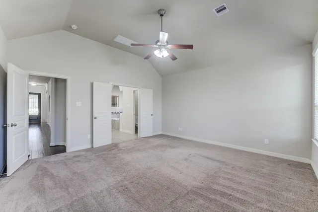 an empty room with fan and entrance