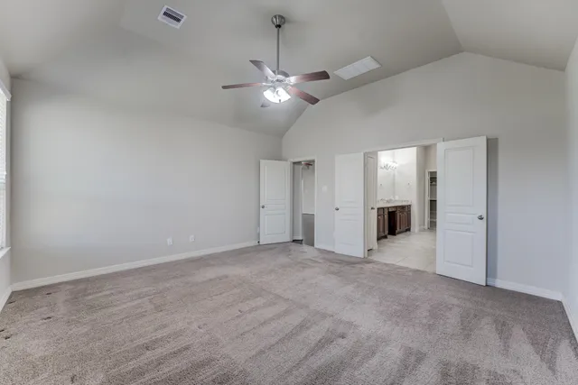 an empty room with fan and ceiling fan