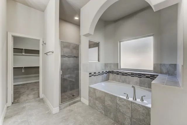 a bathroom with a tub and a shower