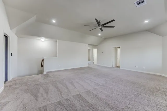 a view of an empty room with a ceiling fan